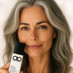 Woman holding a skincare product with a neutral background