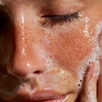 Close-up of a person's face with soap bubbles on their skin